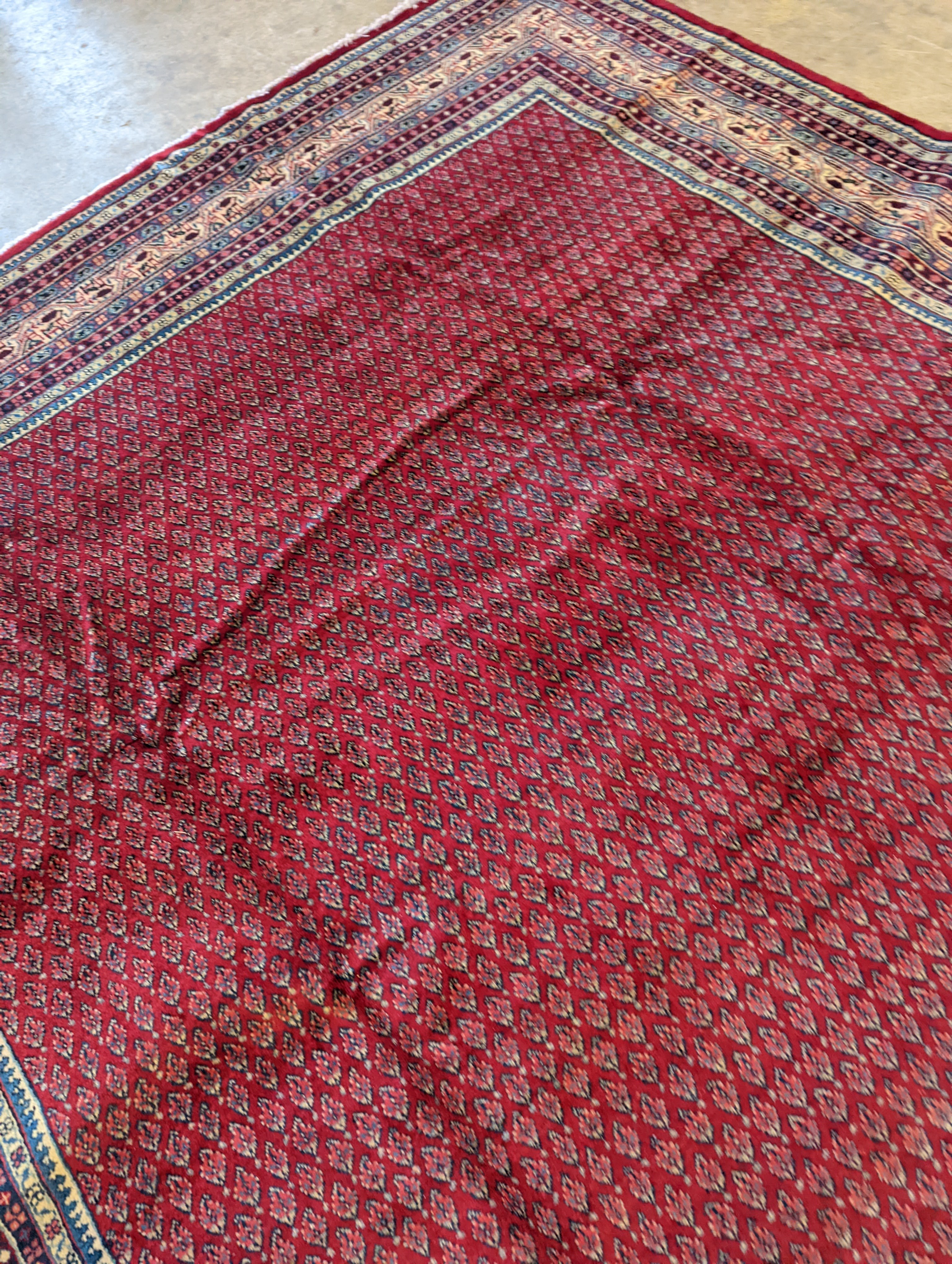 An Araak crimson ground carpet, 350 x 250cm